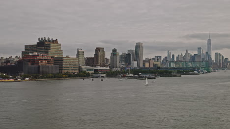 NYC-New-York-Aerial-v236-flyover-Hudson-river-capturing-Chelsea-piers,-waterfront-cityscape-of-Midtown-West-Manhattan-with-sailboats-sailing-on-the-water---Shot-with-Inspire-3-8k---September-2023