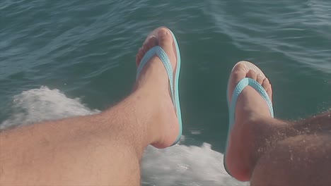 Man-using-flip-flops-on-a-boat-trip