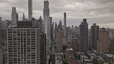NYC-New-York-Aerial-v320-drone-flyover-in-between-Lenox-Hill-and-Midtown-Manhattan-along-59th-Street-capturing-urban-cityscape-against-cloudy-sky---Shot-with-Mavic-3-Pro-Cine---September-2023