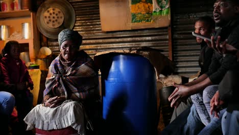 Lady-owner-of-shebeen-listening-intently-to-tourist-guide-explaining-how-things-work-in-the-township