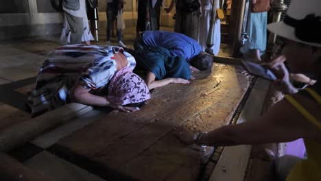 Pilgrims-praying-by-The-Stone-of-Anointing-in-Church-of-the-Holy-Sepulchre