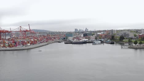 Helicopter-flying-trough-Vancouver-harbor-preparing-to-land-on-helipad