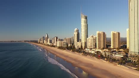 Beautiful-aerial-sunrise-on-the-Gold-Coast-with-nice-beach,-ocean-and-swimmers-for-a-perfect-holiday-destination-in-summer