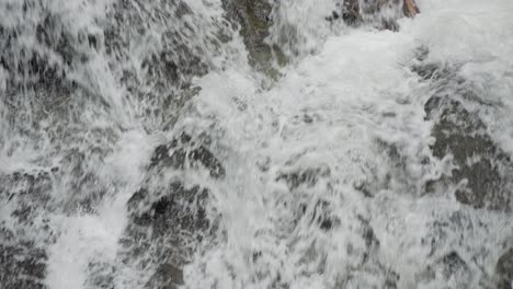 Eine-Nahaufnahme-Des-Herabstürzenden-Wassers,-Das-Den-Goa-Rang-Reng-Wasserfall-Auf-Der-Insel-Bali-In-Indonesien-Hinunterfließt