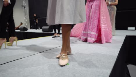 Group-of-Miss-Beauty-Contest-Pageant-rehearsal-practice-on-empty-stage-in-position-and-catwalk-fashion-show-in-Evening-Dress-Gown-walk-around