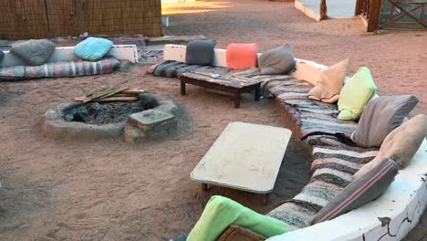 View-of-an-authentic-bedouin-village-fire-place-in-the-desert-during-sunset