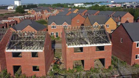 Residential-housing-estate-aerial-view-unfinished-property-framework-on-building-development-site-during-recession-zoom-in-shot