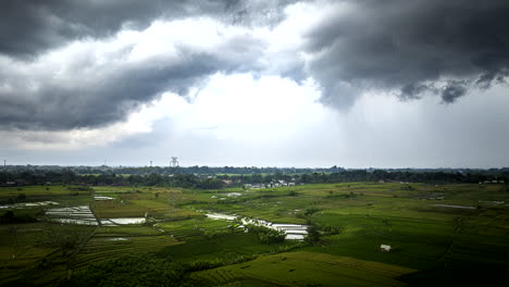 Hyperlapse-timelapse-of-clouds-moving-over-green-rice-fields-in-Balinese-countryside,-Indonesia
