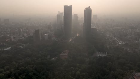 Aerial-view-of-skyscrapers-on-Paseo-de-la-Reforma-during-an-environmental-contingency-in-Mexico-City