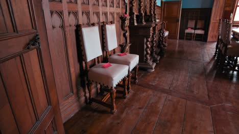 Elegantly-carved-chairs-and-detailed-wood-paneling-in-Trakošćan-Castle's-dining-room,-Croatia