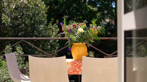 Slow-establishing-shot-of-flowers-sitting-ontop-of-a-table-at-a-villa-in-Montpellier