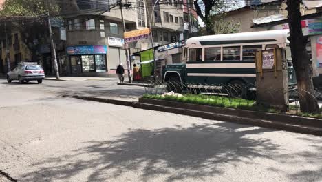 Micro-bus-passing-through-the-street-in-the-city-of-La-Paz,-Bolivia