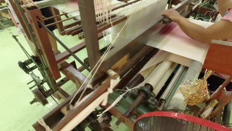 Weaving-a-traditional-Thai-dress-on-an-old-wooden-loom-at-the-Jim-Thompson-Silk-farm-in-Nakhon-Ratchasima-Thailand