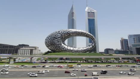 Dubai-traffic-on-Sheikh-Zayed-Road,-framed-by-the-Museum-of-the-Future-and-Emirates-Towers-in-the-background,-United-Arab-Emirates