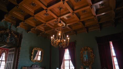 Music-Saloon-in-Trakošćan-Castle-,-Croatia,-featuring-ornate-furniture-and-a-chandelier