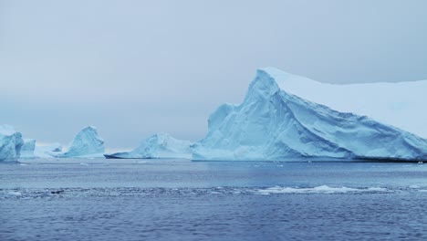 Antarctica-Beautiful-Iceberg-Scenery-with-Amazing-Shapes-of-Big-Blue-Icebergs,-Large-Bizzare-Dramatic-Icebergs-in-Ocean-Sea-Water-in-Cold-Winter-Seascape-Landscape-on-Antarctic-Peninsula