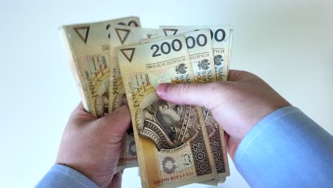 Businessman-counts-two-hundred-zloty-banknotes.-Money-them