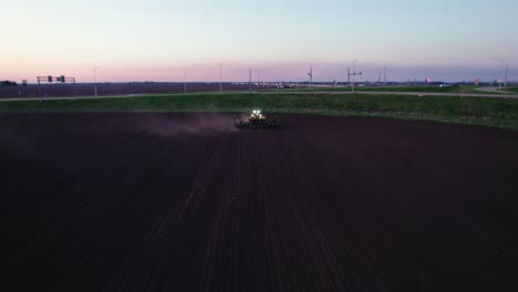Tractor-plowing-field-at-dusk