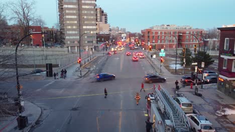 Twilight-city-scene-with-emergency-response-in-Montreal,-Canada,-fire-trucks-and-urgency,-aerial-view