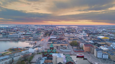 Twilight-aerial-panoramic-view-over-Helsinki-city,-southern-capital-of-Finland