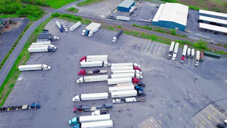 Aerial-view-of-TA-truck-stop-parking-lot-in-Pennsylvania,-filled-with-semi-trucks