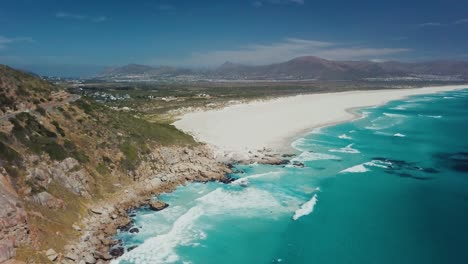 Drone-flying-higher-revealing-the-scenic-beach-of-Cape-Town-South-Africa