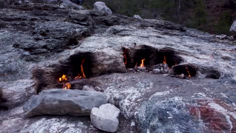 Eternal-Flames:-Natural-Gas-Fireplace-Burning-Out-of-Stone-Rocks-at-Mount-Chimaera,-Turkey
