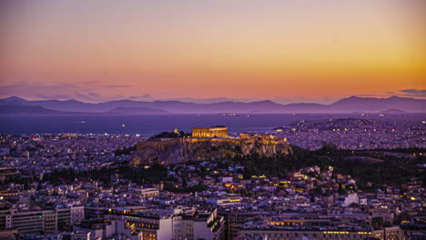 Sunset-over-Athens,-Greece-with-the-Acropolis-and-ships-in-the-gulf-harbor---time-lapse