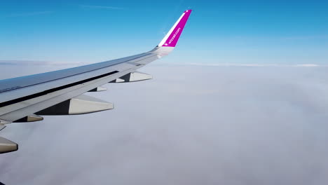 An-aerial-view-of-a-plane-flies-above-the-clouds