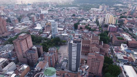 Dawn-breaks-over-the-Metropolitan-Cathedral,-heart-of-Medellin,-Colombia,-Aerial