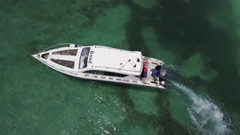 Aerial-low-shot-of-a-yacht-over-clear-waters-in-a-tropical-island-of-Bali