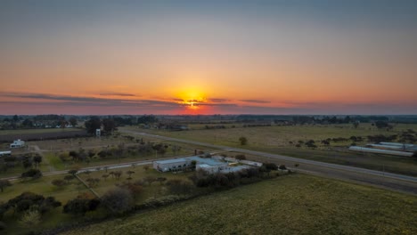Country-fields-route-houses-sunset-time-lapse-aerial-drone-panoramic-truck-shot