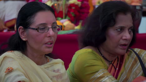 Zwei-Hindu-Frauen-Singen-Und-Werfen-Opfergaben-In-Ein-Rituelles-Feuer