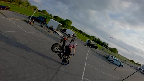 Stunt-biker-does-a-stoppie-trick,-filmed-with-an-FPV-drone