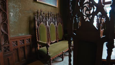 Ornate-wooden-chairs-and-bench-in-the-Small-Library-of-Trakošćan-Castle-,-Croatia