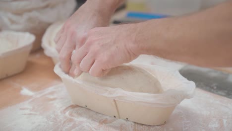 Forming-the-loaf-of-bread-from-wheat-dough-in-a-bakery