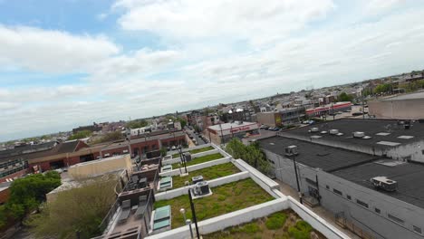 FPV-Drone-shot-of-urban-housing-and-apartments-with-green-grass-on-rooftops