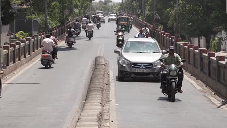 pov-shot-Lots-of-bikes-cars-are-coming-and-lots-of-bushes-are-also-seen-around