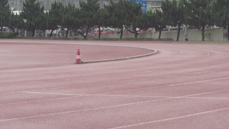 Regentag-Auf-Leerem-Laufplatz,-Schotterlaufbahn-Im-Regen,-Kwai-Chung-Sportplatz-Hongkong