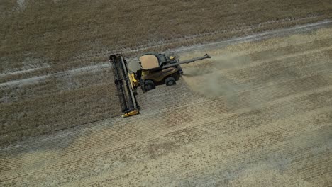 Tractor-harvesting-grain.-Aerial-top-down-orbiting
