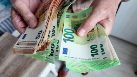Senior-man-counting-savings-in-euro-banknotes,-finances,-savings-and-people-concept