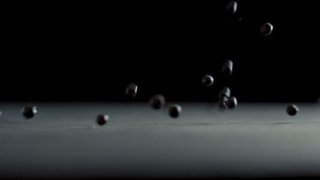 Juniper-grains-fall-on-the-table-in-slow-motion