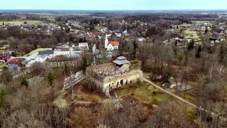 Aerial-drone-panoramic-autumnal-town-in-european-countryside-Rauna-castle-ruins