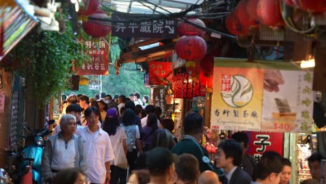 Jiufen-Old-Street,-a-charming-Taiwan-mountain-village,-bustles-with-crowds-wandering-through-narrow-lanes-lined-with-food-stalls,-souvenir-shops,-and-quaint-gift-boutiques