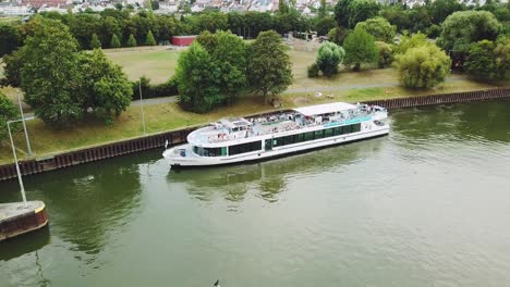 flying-around-a-boat-on-the-sewer-of-Frankfurt-am-Main-Germany,-paning-left