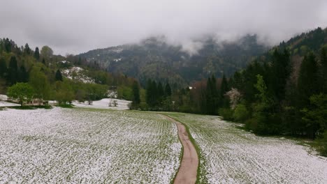 City-surrounding-the-Dolomites-Mountains-in-Italy-wintertime-snow-drone-4k