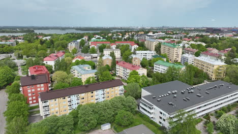 Drone-orbiting-vibrant-condiminium,-summer-in-the-Drumso-district-of-Helsinki