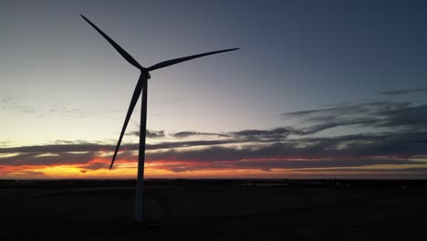 Silhouette-of-wind-turbine-spinning-at-twilight