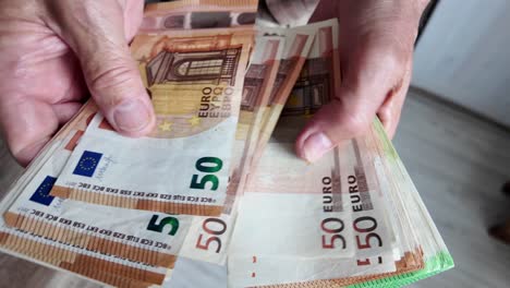 Pensioner-man-counts-euro-banknotes,-savings-for-old-age