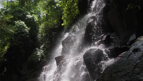 Mesmerizingly-illuminated-Kanto-Lampo-waterfall-cascades-gracefully,-creating-a-scene-of-ethereal-beauty-and-wonder